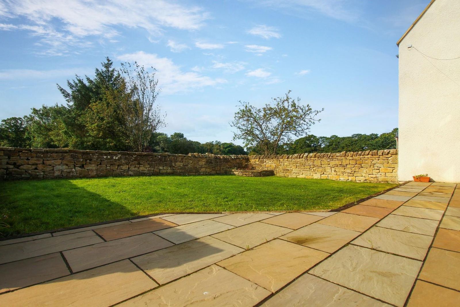 Block paving laid between the two buildings.