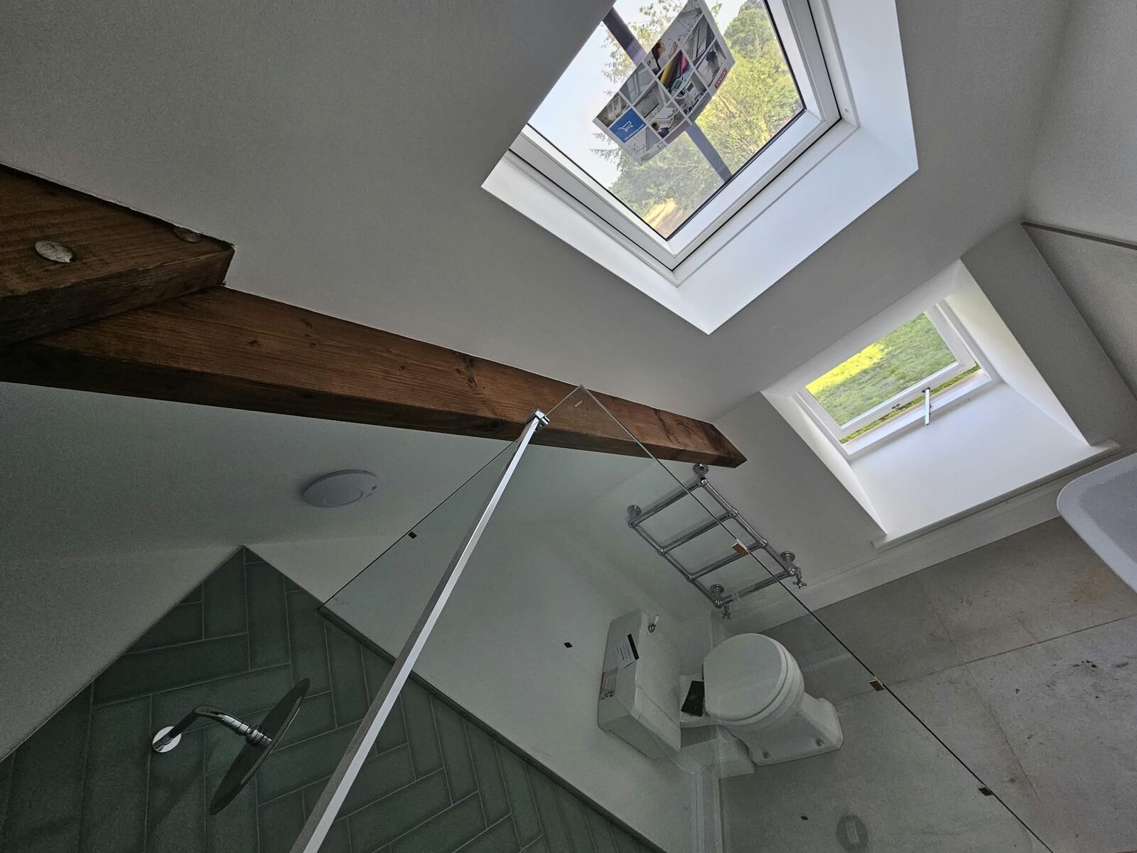 The same bathroom, looking up to the rooflights in the sloped ceiling.