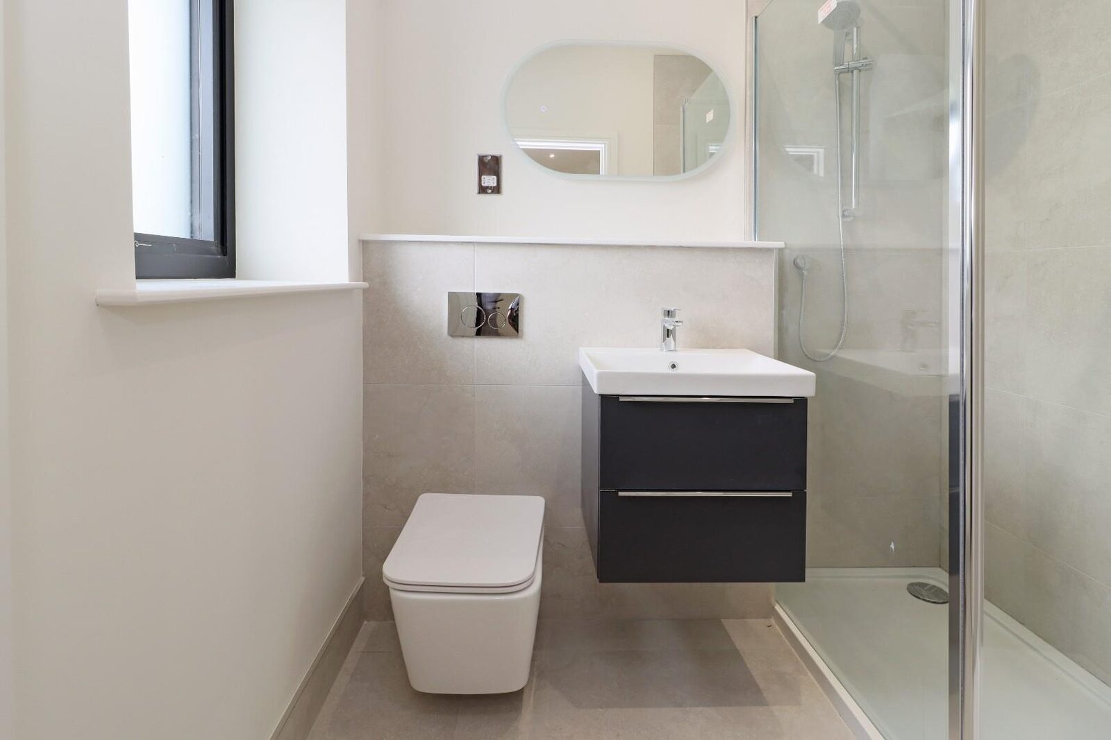 A wet room with a wall hung vanity unit.