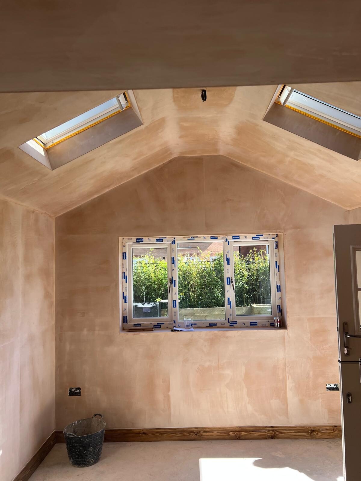 Inside the converted garage, freshly plastered with two rooflights