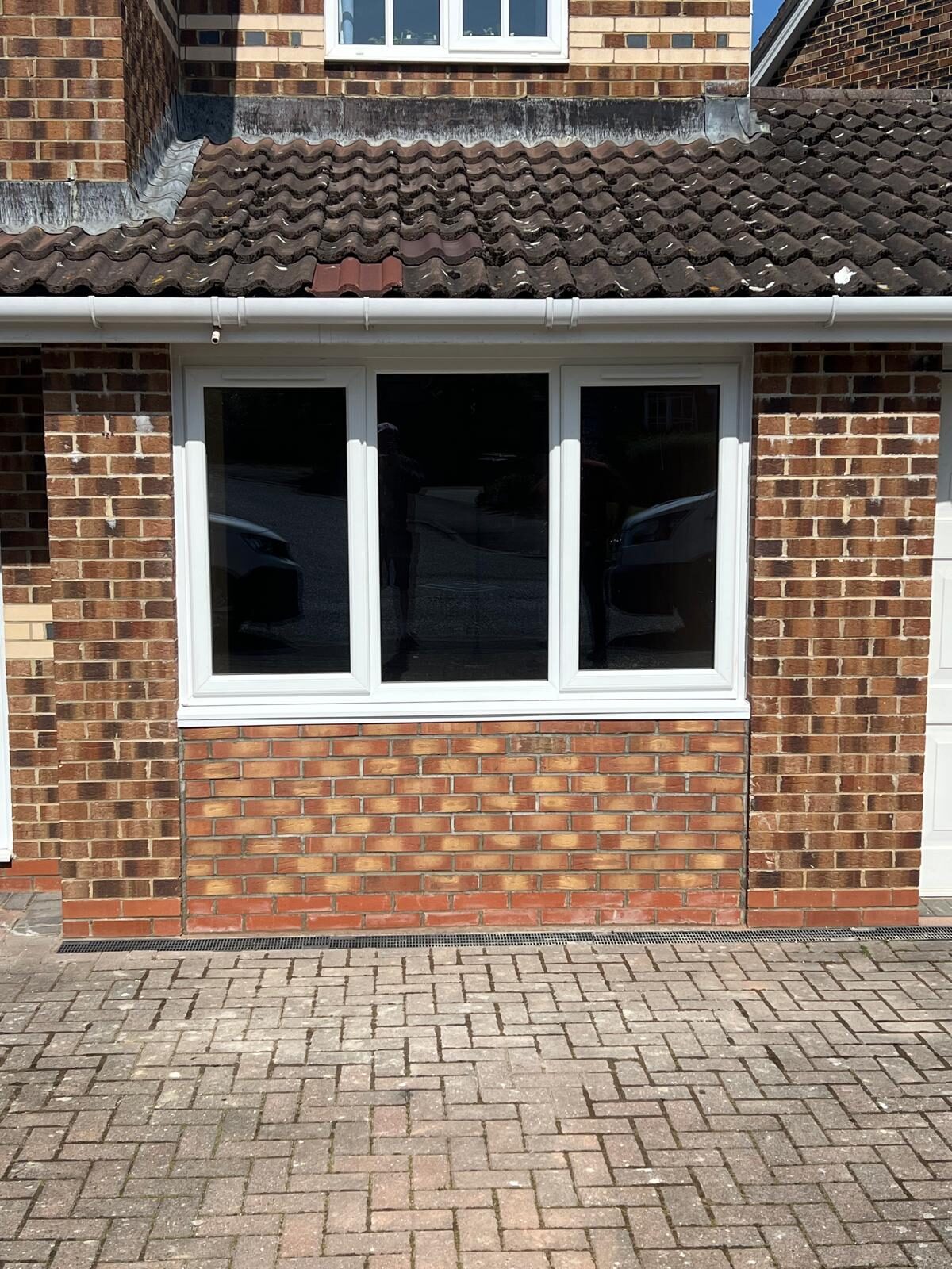 The converted garage from outside, a new window in the old opening
