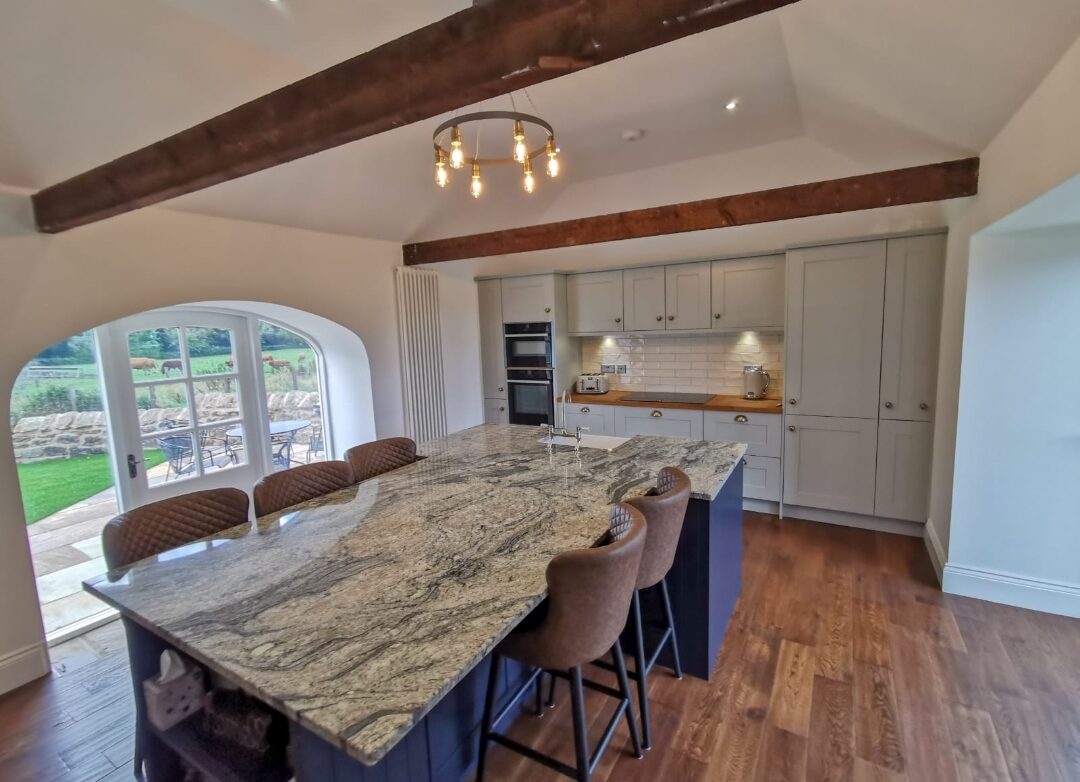 A kitchen with an island, fitted and finished.