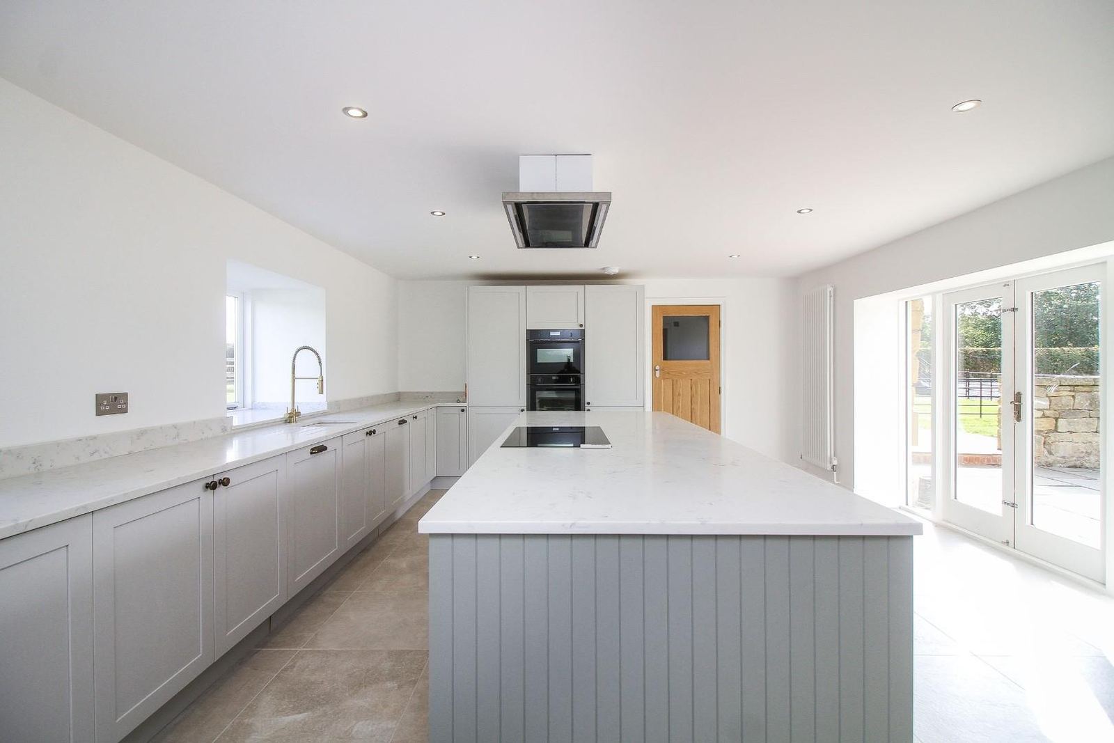 A kitchen with an island, fitted and finished.